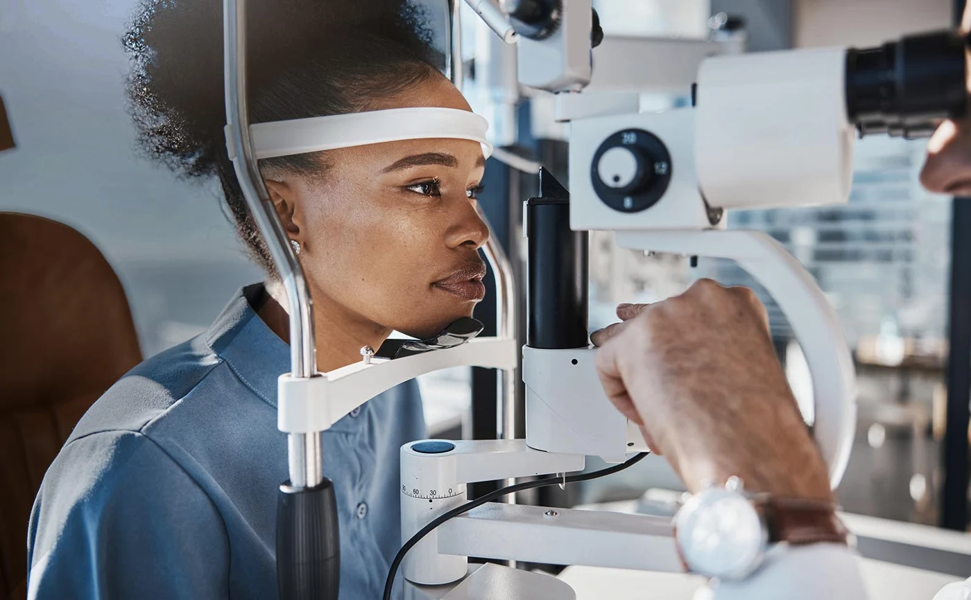 Patient having her eyes examined with a slit lamp